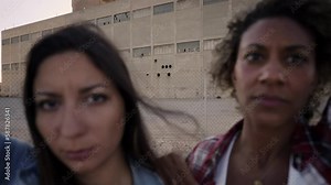 Two woman holding Help me poster claim during a street protestor for climate change. Slow motion. High quality FullHD footage