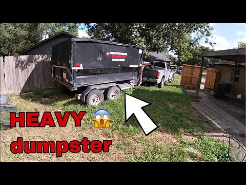 Gooseneck roll off dump trailer loading a heavy dumpster / 18 yard texas pride roll off