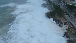 Huge tropical cyclone waves crushing and flooding a city coastline - aerial view Premium Stock Video Footage