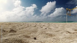 Time lapse of a beach in Mauritius with a volleyball net on the right hand side, and the sea in the horizon.