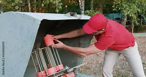 young man putting clay targets, preparing Clay discs to shoot, ready to shoot in an outdoor range. hobby, man collect Clay pigeons or shotgun discs