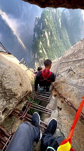 Walk the thrilling iron path on Mount Huashan cliffside Would you dare climb this iron path built along a #cliff of Mount Huashan? #mountain #travel #adventure | WE ARE CHINA
