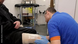 Preparing and fitting a bionic leg for a patient at a rehabilitation center. Healthcare, modern developments.