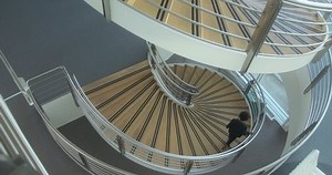 clip-1091217169-businesswoman-walking-down-stairs-office-on-way