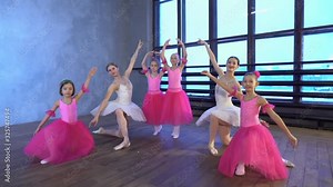 Little girls dance ballet. Children in ballet class. Little ballerinas and teacher. Beautiful view.