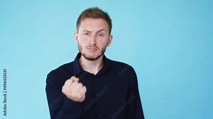 Angry man. Threaten gesture. Rage expression. Boomerang animation. Offended aggressive guy raising clenched fist isolated on blue background GIF loop motion.