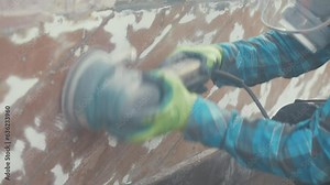 Fairing paint of a mahogany planked hull using an orbital sander
