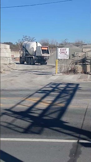 A Mack rear engine cement mixer truck
