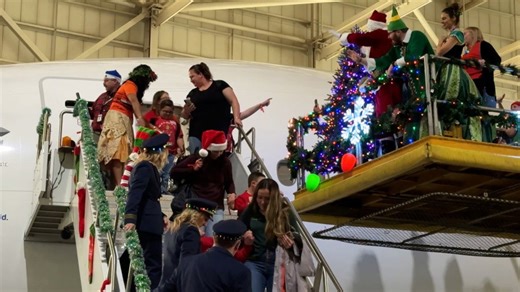 Kids board a United 777 for a trip to the North Pole at DIA