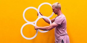Circus performer creates an optical illusion with rings
