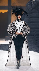 … take thy beak from out my heart … as the raven, anna cleveland wears an oversized puffer tailcoat in deconstructed tuxedo suit tweed lined with white moire over a square shoulder dress, and trompe l’oeil shirt and vest tipped with ribbon and black pearl, with pleated grosgrain and silk ribbon applique. ‘the raven’ by edgar allan poe is read by carrie coon. thom browne fall 2024 collection. #thombrowne #thombrownefw24 | THOM BROWNE.