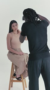 Photographer portraying a woman on a white background - Free Stock Video