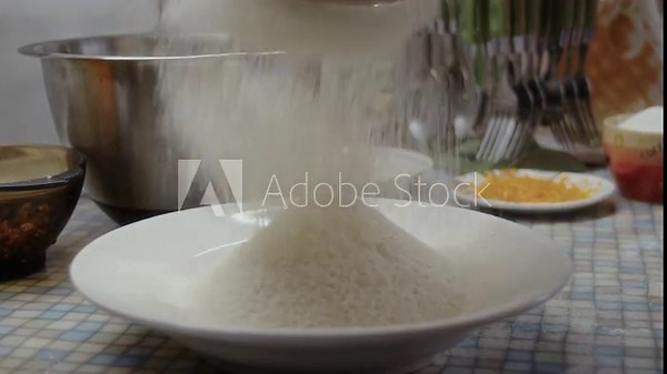 Close-up, the process of sifting flour through a sieve on a kitchen baking table