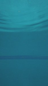 Girl jumps into the pool, seen from underwater - Free Stock Video