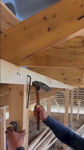 Roof Structure Reinforcement: Securing the Support Beam with a Metal Bracket