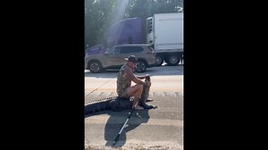 Barefoot man seen wrestling large alligator on interstate, Florida video shows