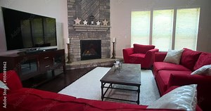 Modern Living Room Revealed from Behind Sofa. camera rises from behind a couch to reveal a modern furnished living room with red furniture, a fireplace, and entertainment console