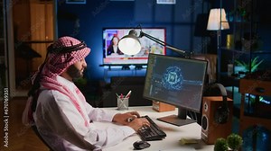 Trained arabic technician updating neural networks, writing intricate binary code scripts on computer. Middle Eastern man uses digital device programming to upgrade AI with TV as background noise
