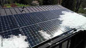 Snow Sliding Off Solar Panels on a Rooftop in a Residential Area