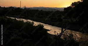 Timelapse of the Santa Clara River running through Santa Clarita, Ca. with Six Flags Magic Mountain in the distant background.