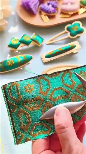 Turquoise fabric gleams gold patterns adorn clips