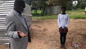 SCHOOL SHACKS … Oshamukweni Combined School principal Werner Nangolo explains the purpose of The Namibian’s visit to Grade 7 learner Bertha Hanghome, as pupils cook porridge outside their shacks in which they live on the school premises. Video: Eliaser Ndeyanale | The Namibian