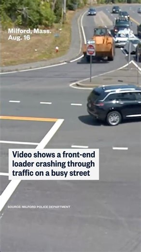 Video shows a front-end loader crashing through traffic on a busy street