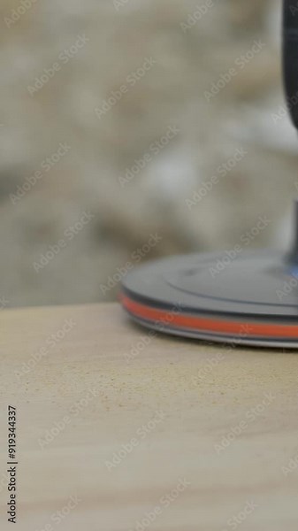 Sanding machine is in use on wood, its repetitive motion effectively smoothing out the surface and preparing it for further processing. Power tool used to smooth surfaces by abrasion with sandpaper