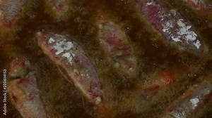 Close up cooking deep fried red mullet fish in oil