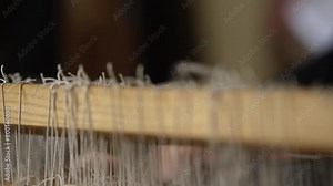 Person operating weaving machine pulls handle attached to string Stock Video