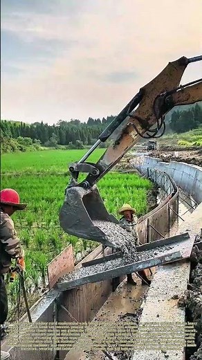 Diverting wet concrete: How excavator buckets feed formwork for rural irrigation channels