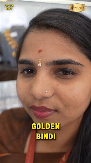 Navyaa Aabharan on Instagram: "✨Stick, shine, done. ✨ Golden pearl bindi with skin-friendly gum; no piercing, just pure charm💛 #goldenbindi 📲 Download our App! https://navyaaaabharan.qrplanet.com/download_app 📍 Navyaa Aabharan 432, Krishna Mane, Old Post Office, Padma Shree Oil Mill Road, KR Puram, Bengaluru – 560036 ☎️ 9964646924 #goldjewellery #silverjewellery #bridaljewellery"