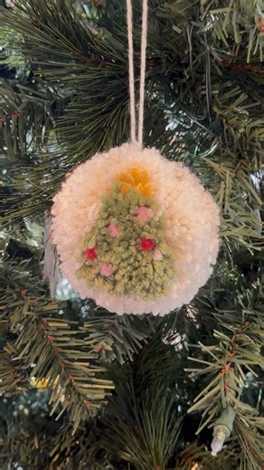 Katherine | Cheers to Monday | DIY on Instagram: "DIY Christmas Tree Pom-Pom 🎄🧶 Made a pom-pom with a Christmas tree design right in the middle. I used a pom-pom maker (because the cardboard circle hack never works for me 😅) and wrapped the yarn so the tree pattern formed as I went. Green yarn for the tree, white yarn for the background, pipe cleaners for ornaments (they’re easy to adjust since the pom-pom never comes out perfect), and a tiny yellow fabric scrap (or yarn) for the star. Once i