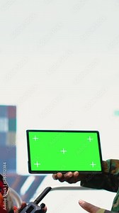 Vertical video Green screen mockup tablet used by naval unit on drilling rig safeguarding infrastructure. Army soldier on offshore platform prevents piracy, using chroma key device to make security Stock Video