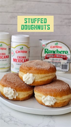 Stuffing everything with Cacique Crema Mexicana and Cacique Ranchero Queso Fresco from now on 😮‍💨 Ingredients: 1 cup Cacique Crema Mexicana 1 package Cacique Ranchero Queso Fresco 6 plain unfilled donuts ¼ cup powdered sugar 1 tbsp pure vanilla extract 1/3 cup sugar 2 tbsp cinnamon Directions: 1. On a plate, combine the regular sugar and ground cinnamon and set aside. 2. In a medium mixing bowl, add Cacique Crema Mexicana, Cacique Ranchero Queso Fresco, powdered sugar and pure vanilla extract.