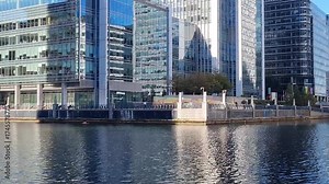 London, Canary Wharf area view form the South Dock at sunny day. London, UK 2025