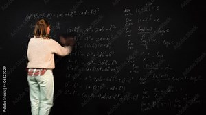 Time lapse of a female student writing algebra formulas and drawing graphics on blackboard. A young caucasian woman solves scientific problem. Teacher is focused on studies and explains math material.