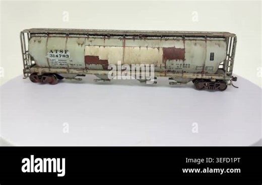 American railroad wagon model with weathering effects rotating on a model railway turntable in USA, showing miniature freight car and rail yard operations with tracks, depot infrastructure, and realistic mechanical movement Stock Video Footage - Alamy