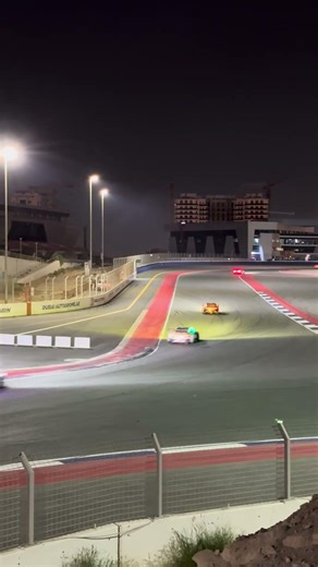 Dubai 24h race at night - race cars going through Turn 2 and 3