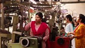 Female workers working at production line in textile factory and...