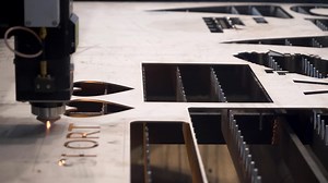 Close up of laser cutting process at the exhibition of modern industrial technologies. HDR. Demonstration of metal sheet laser cutting.