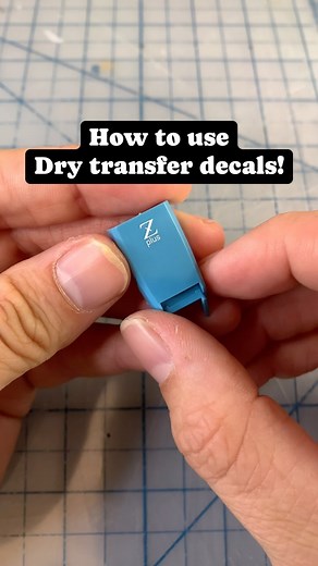 Luke on Instagram: "How to use dry transfer decals! 👇🏻 Dry transfers are another common decal seen in older/modern mastergrades, and look amazing when done correctly! But they can be a paint to apply. Here’s how I do it: 1. Identify the dry transfer sheet in the kit. It’s easily noticed due to the wax paper backing. 2. Cleanly and carefully cut the decal out with a hobby knife, leaving some space around the edges. 3. Place it on the piece in the desired spot. 4. Secure it with masking tape. 5.