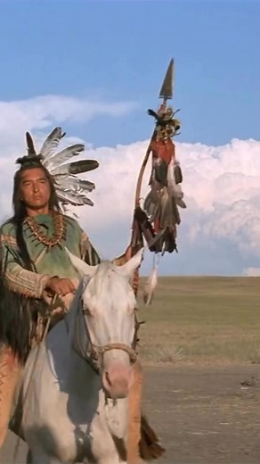 In Dances with Wolves (1990), Lieutenant Dunbar (Kevin Costner) This scene shows John Dunbar pantomiming a buffalo. With no common language, he resorts to hand motions, mimicking horns and stomping, until the message finally lands. Kicking Bird (Graham Greene) watches with curiosity as Dunbar desperately acts out a buffalo. Wind In His Hair (Rodney A. Grant) sits nearby, more skeptical than impressed, as the awkward display slowly begins to make sense. 🦬 | Native Americans Long Ago