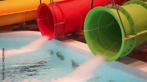 slide pipe with water in the water park. A jet of water