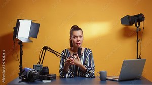 Video blogger explaining how to use a Neutral Density filter. Content creator new media star influencer on social media talking video photo equipment for online internet web show