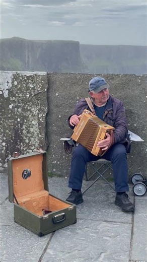 Accordian player at Cliffs of Moher (Ireland)