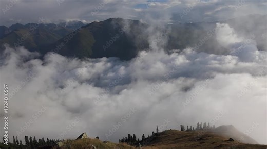 Panoramic cloud sea above alpine meadow ridge at Camlihemsin Rize Turkey Black Sea coast. Broad vista reveals fog ocean topping Pontic Alps, lone hut beside grassy slope in sunset light.