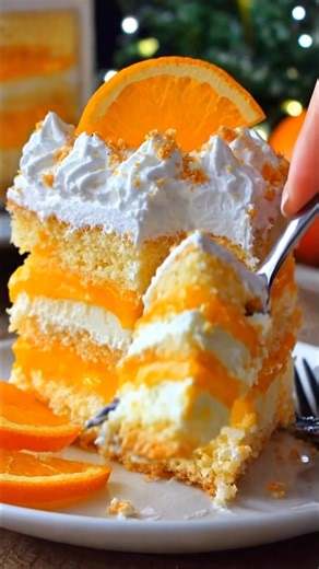 Irresistible Orange Creamsicle Cake Ingredients Cake 15.25 oz vanilla cake mix (about 1 box) 3 large eggs 1 cup milk or vanilla almond milk ½ cup vegetable oil 1 tablespoon orange zest 3.4 oz orange JELLO 1 ¼ cups boiling water ⅓ cup fresh squeezed orange juice 15 oz can mandarin oranges (do not drain) Topping 3.5 oz vanilla instant pudding mix 8 oz Cool Whip (or whipped topping) 👩‍🍳 Instructions 1. Make the Cake Preheat oven to 350°F (175°C) and grease a 9×13-inch baking pan. In a large bowl 