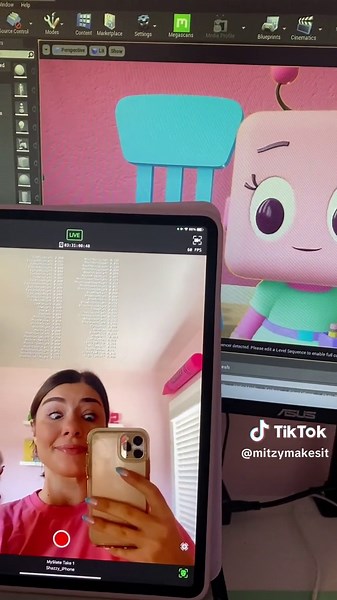 A short breakdown of how I am animating Mitzy in real time! The text on my ipad are the different parts of my face and what they are doing - eye brow up, jaw open, mouth smile and so many more. Theres actually 50 different face shapes! If you download LiveLink on your iphone you can actually try it out in your own face! This technology is set up by Apple and is very similar to how Animojis work. All those values are then sent to my computer where they are mapped to Mitzys face (she has all the s