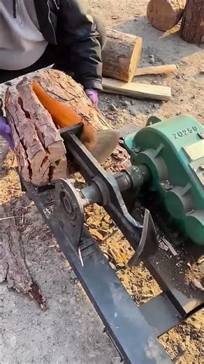 worker uses a rotary log splitter to efficiently process firewood outdoors